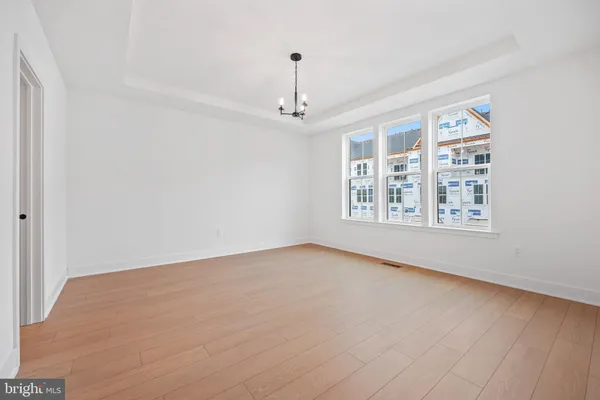 a spacious bedroom with a bed a couch and a window