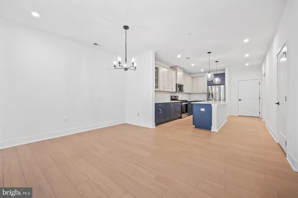a view of a kitchen with a sink and wooden floor
