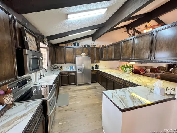 a kitchen with a stove a sink and a refrigerator