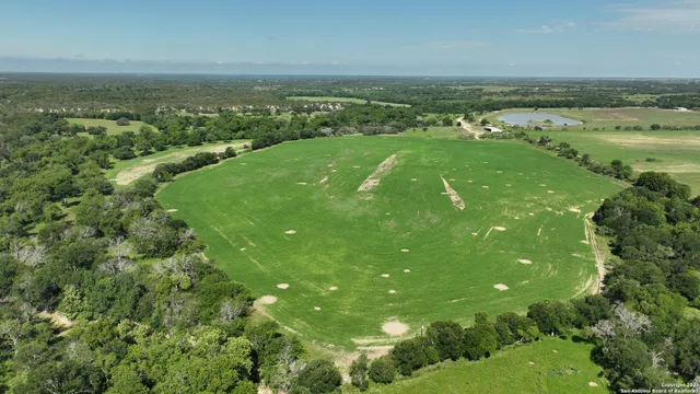 a view of a field with an ocean