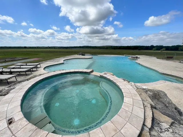 a view of a swimming pool with a yard