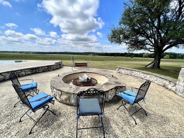 a view of a terrace with furniture and a yard