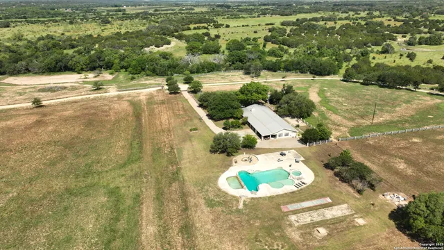 a view of a swimming pool with a yard