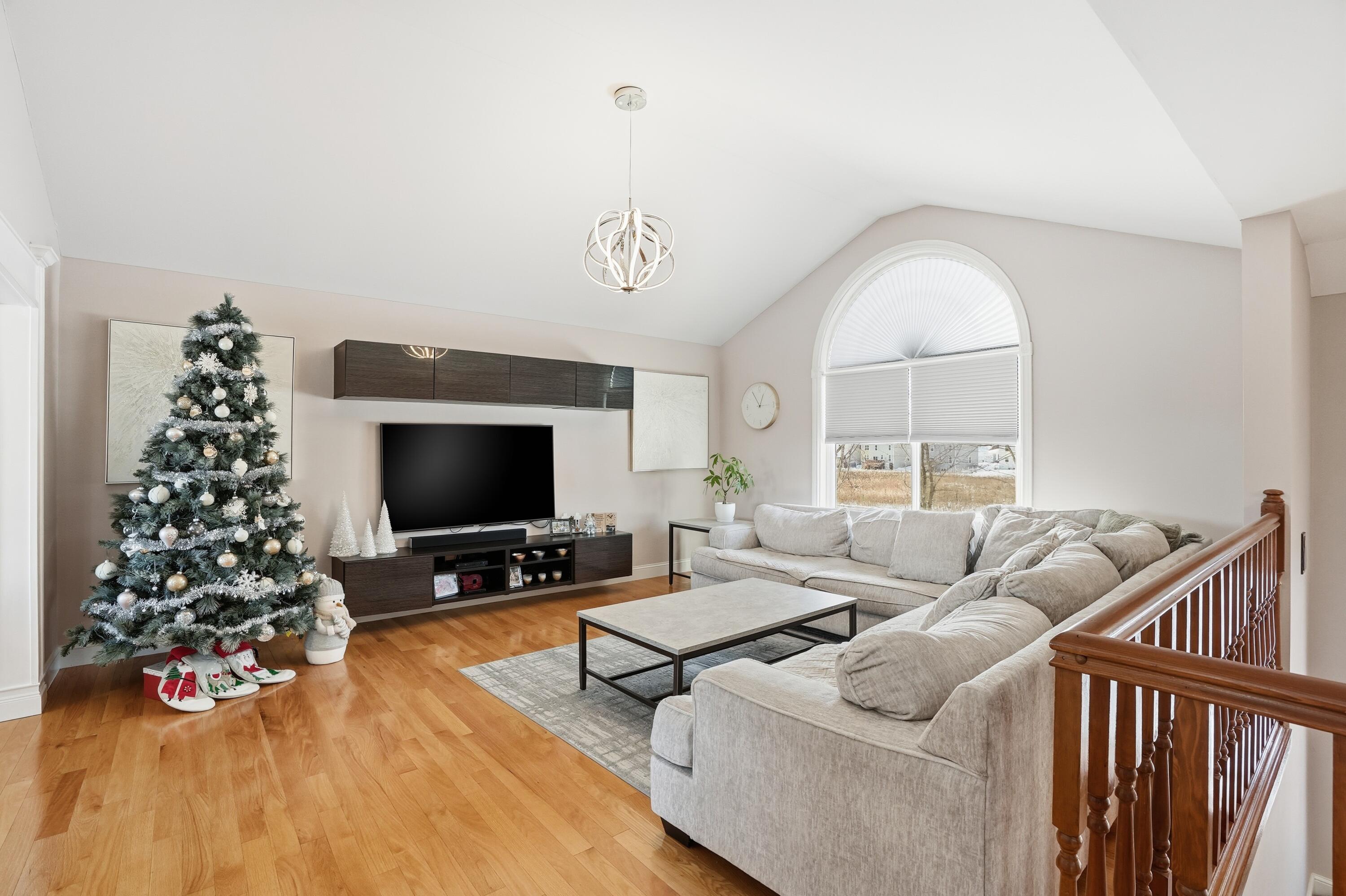 11109 Iowa Street Crown Point, IN 46307 - Photo 11 of 31 a living room with furniture a flat screen tv and a large window