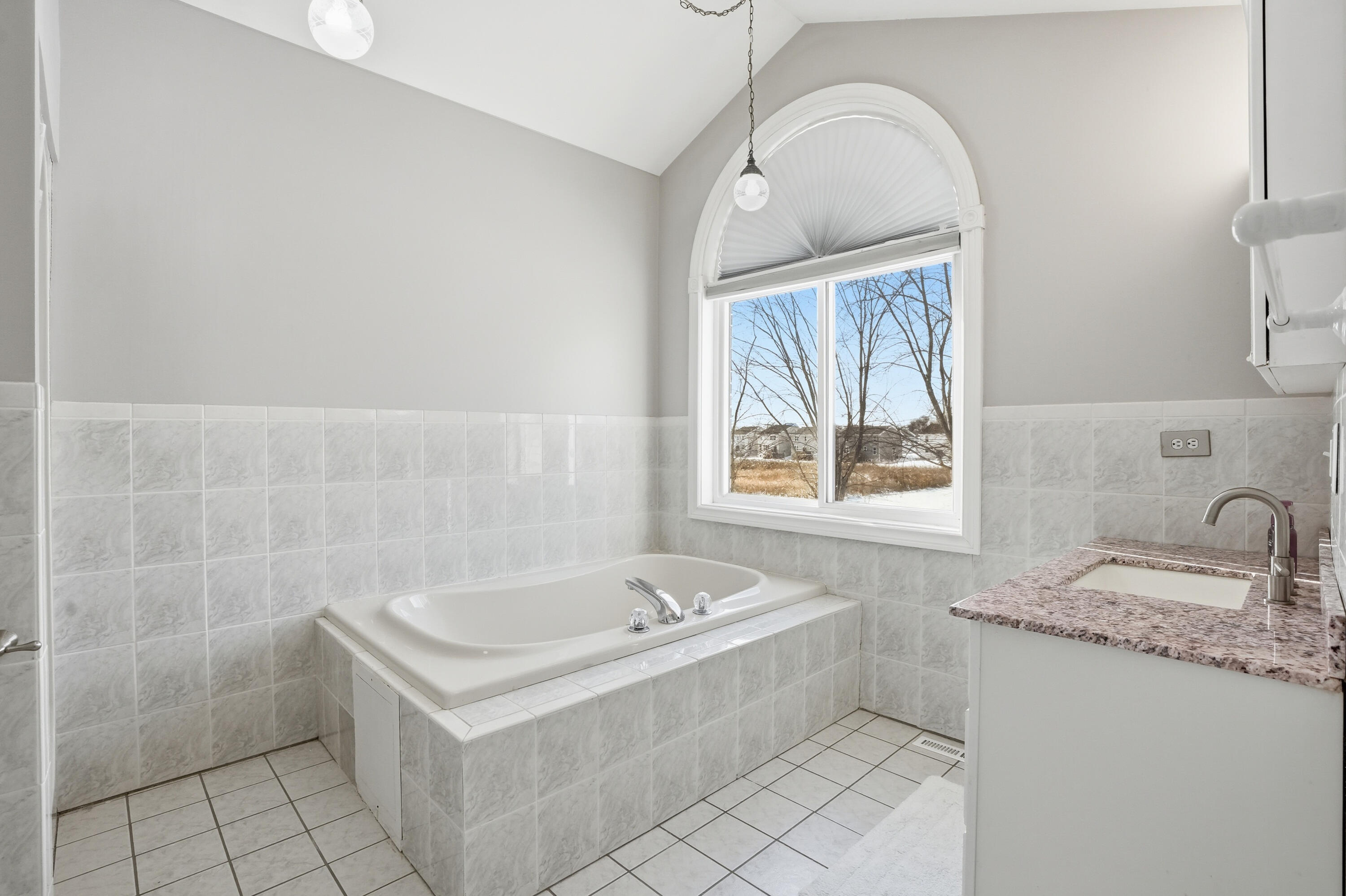 11109 Iowa Street Crown Point, IN 46307 - Photo 14 of 31 a white bath tub sitting next to a white sink