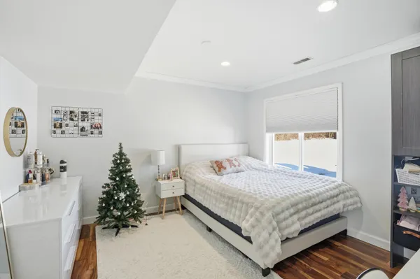 a bedroom with a bed and a potted plant