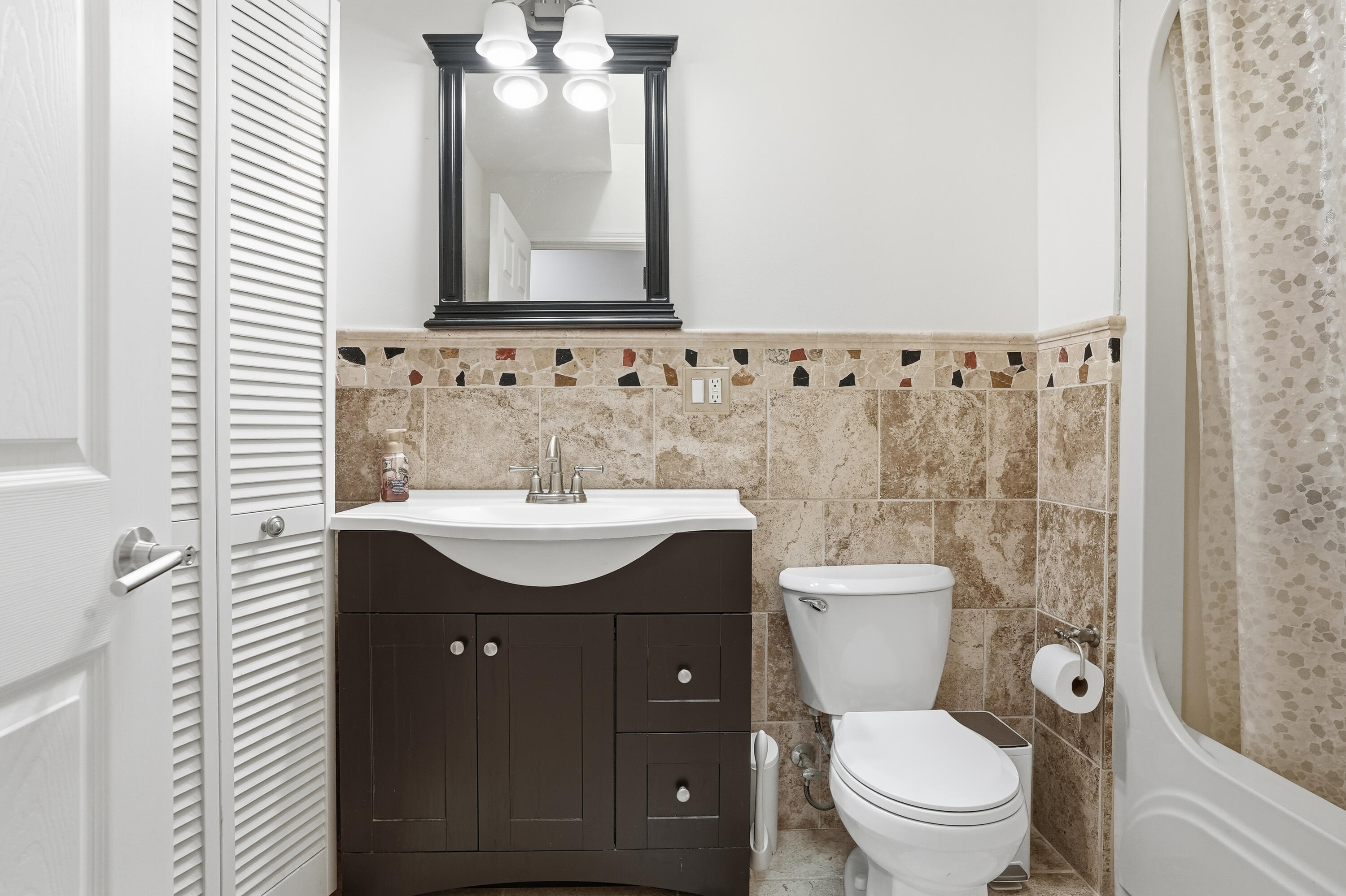 11109 Iowa Street Crown Point, IN 46307 - Photo 19 of 31 a bathroom with a toilet sink and mirror