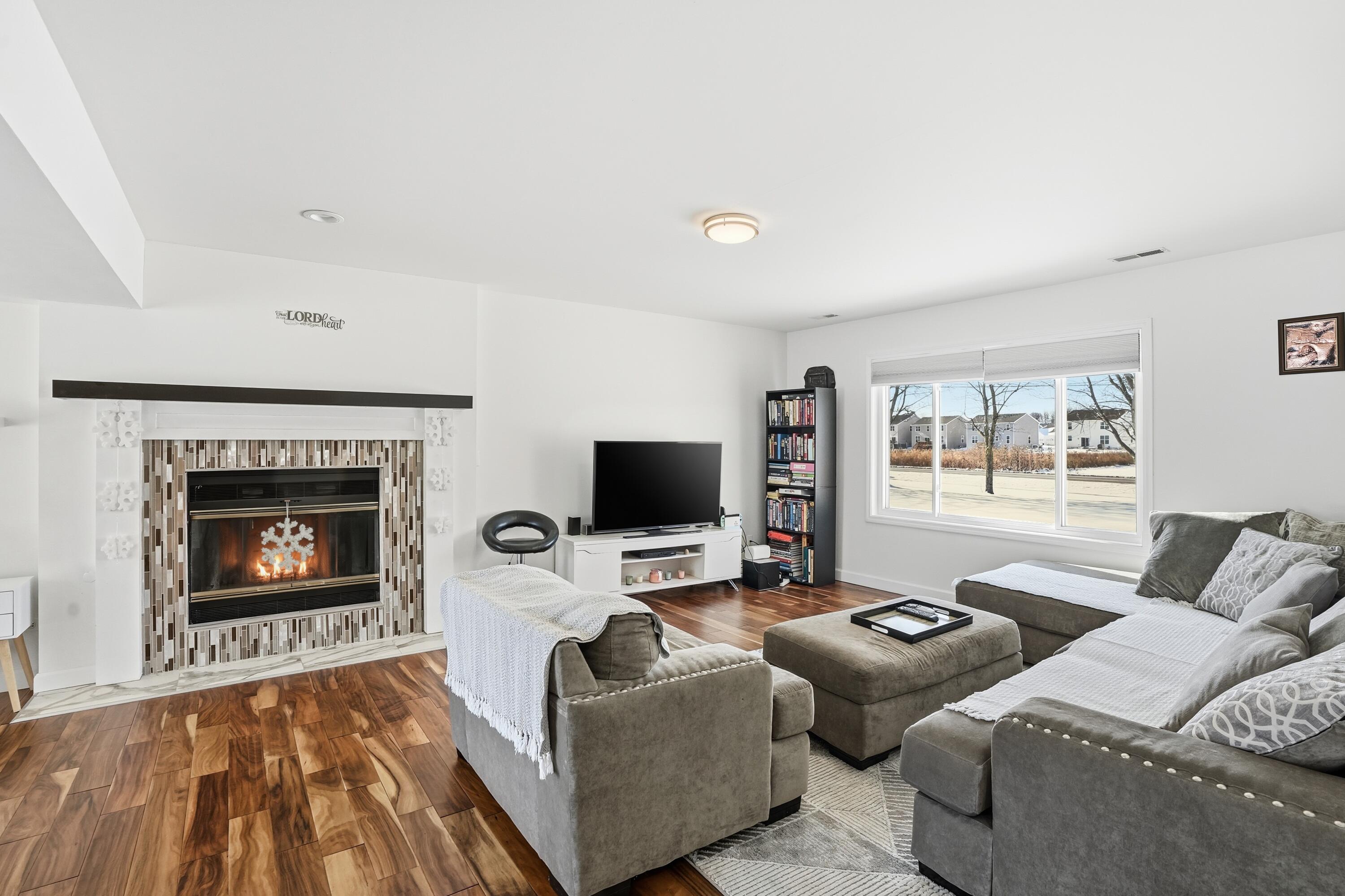 11109 Iowa Street Crown Point, IN 46307 - Photo 20 of 31 a living room with furniture and a fireplace