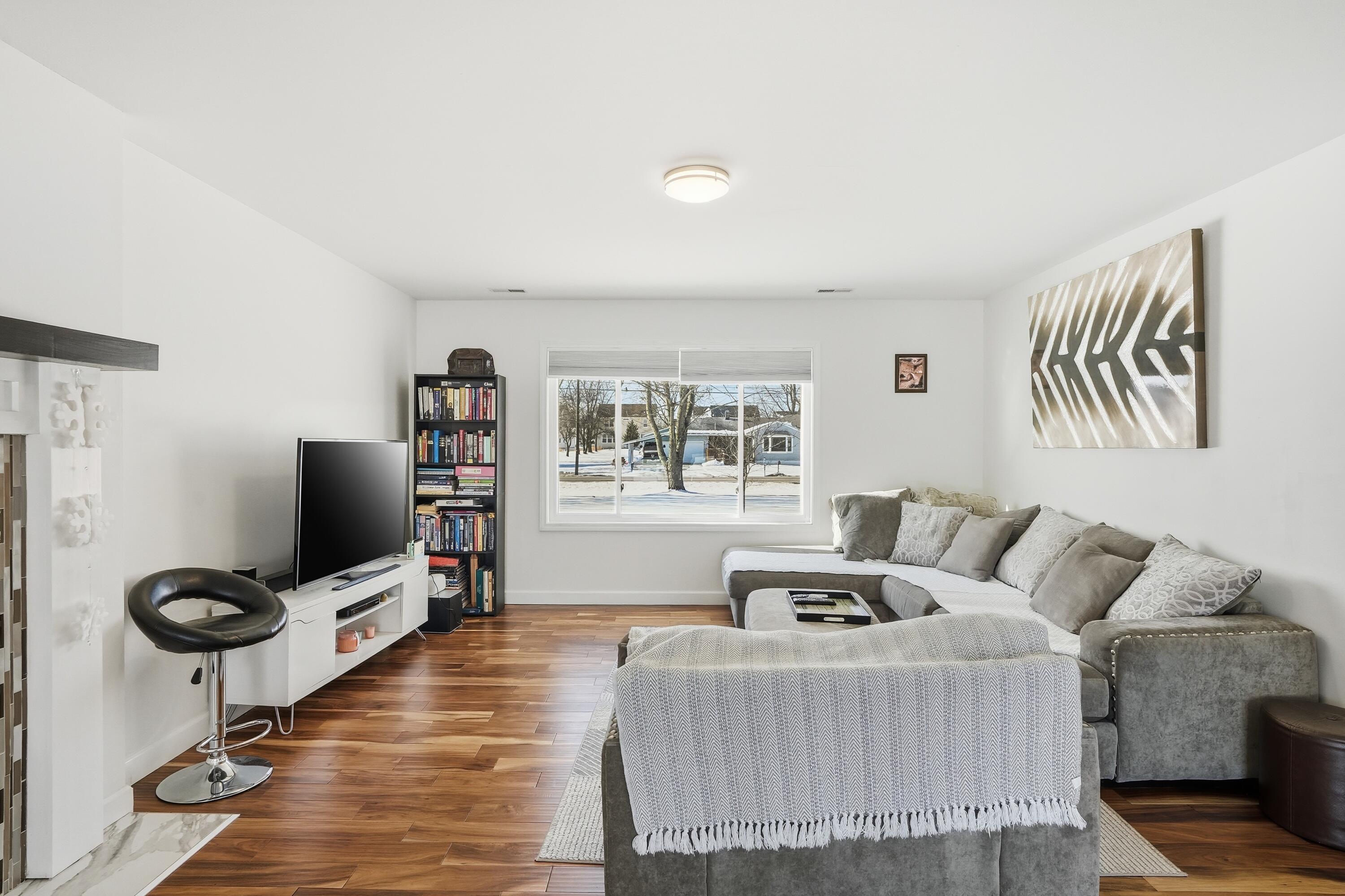 11109 Iowa Street Crown Point, IN 46307 - Photo 22 of 31 a living room with furniture and a flat screen tv