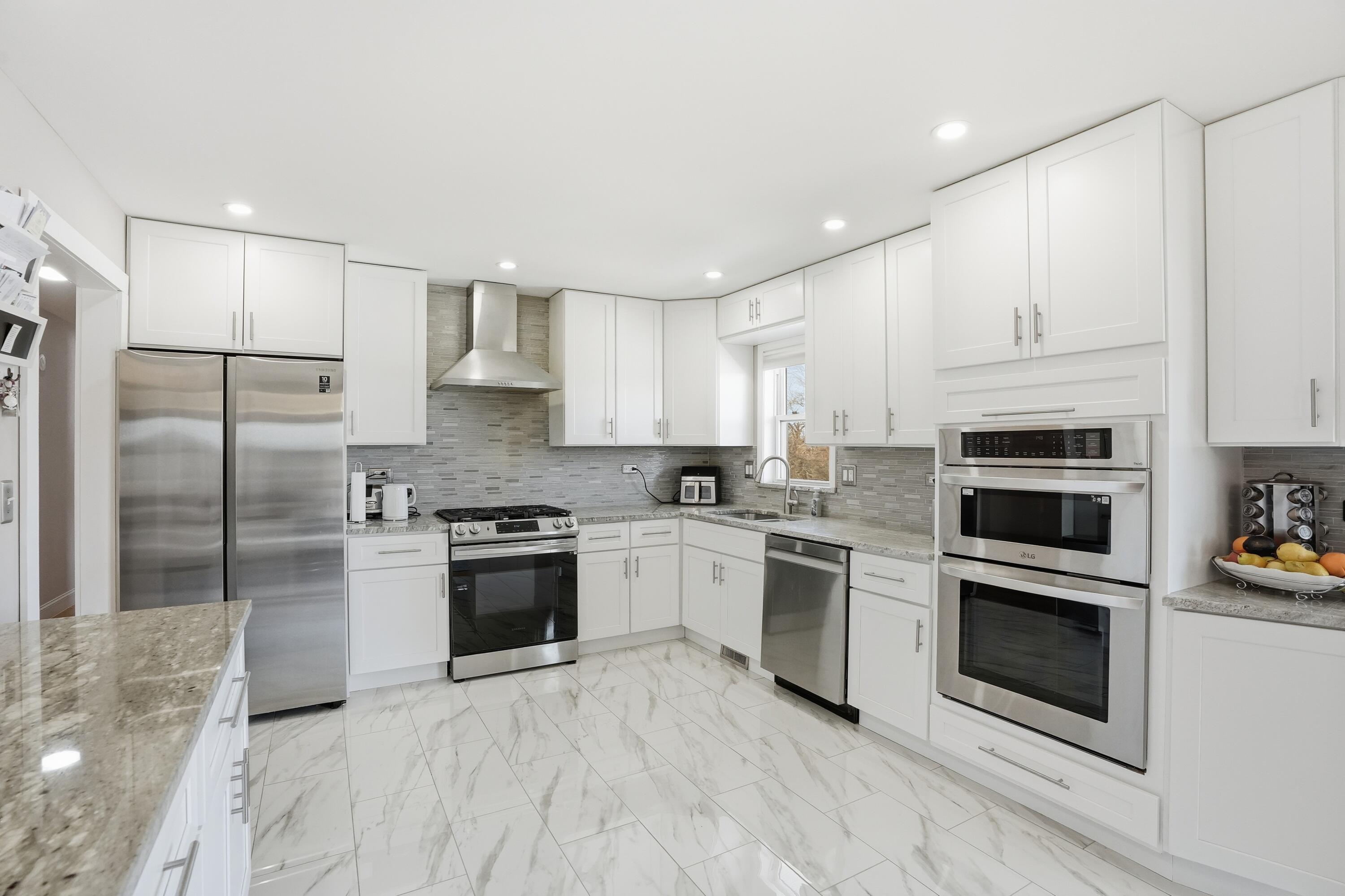 11109 Iowa Street Crown Point, IN 46307 - Photo 4 of 31 a kitchen with stainless steel appliances granite countertop a stove a refrigerator and a microwave