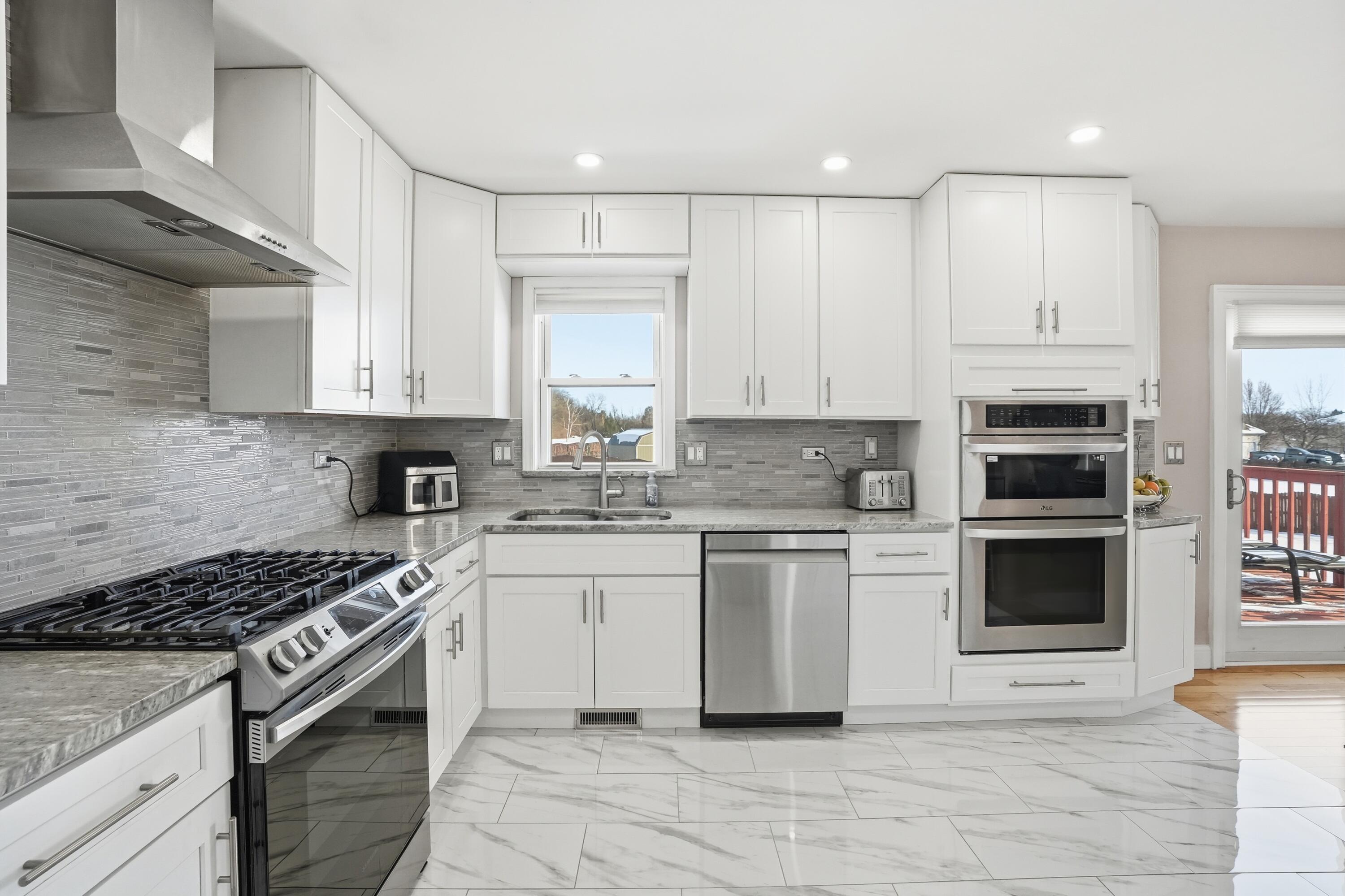 11109 Iowa Street Crown Point, IN 46307 - Photo 5 of 31 a kitchen with stainless steel appliances granite countertop a stove and a sink