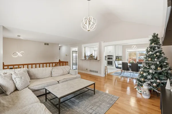 a living room with furniture a large window and a potted plant