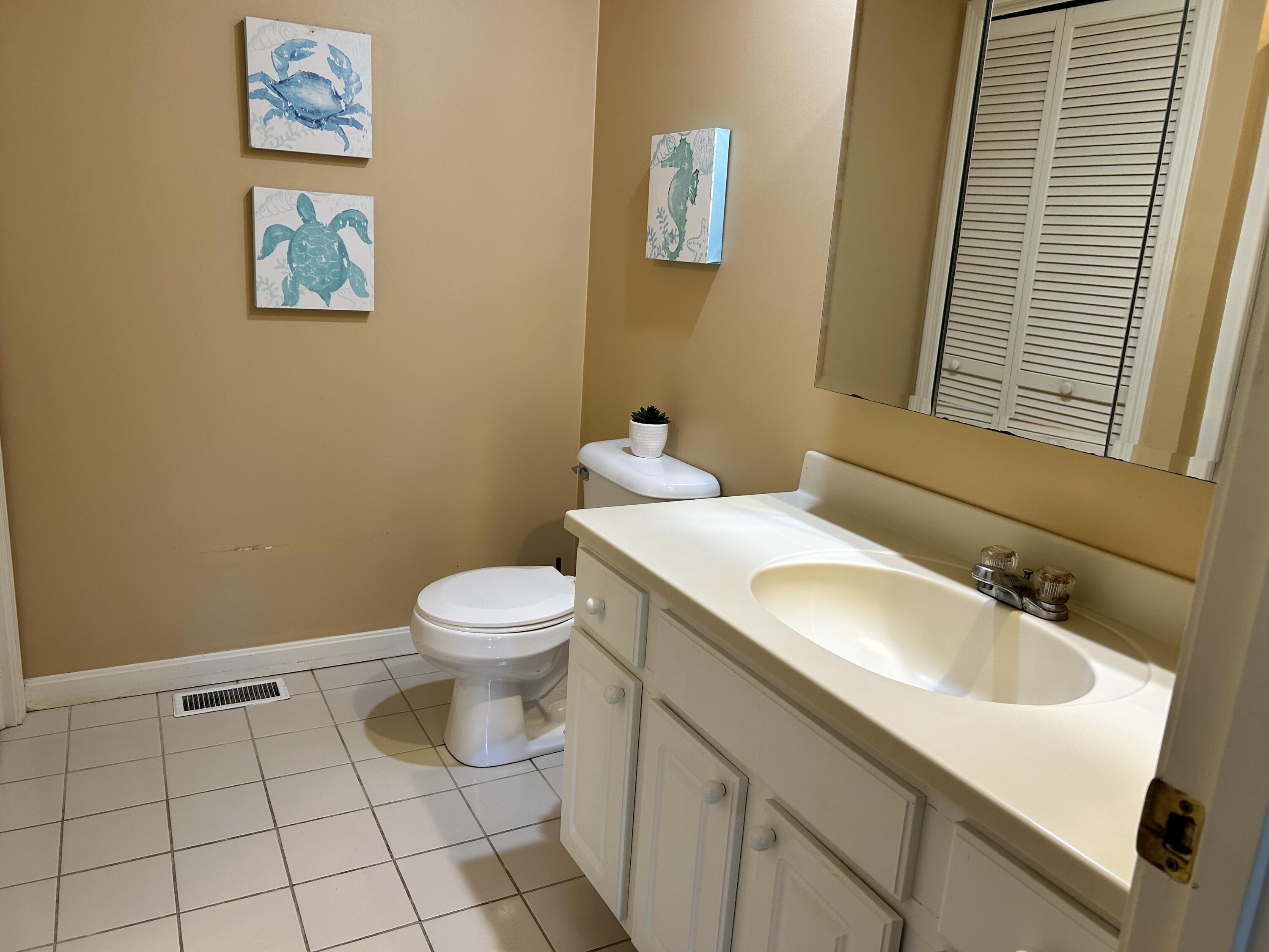 28 Windward Street, Unit 28 Mashpee, MA 02649 - Photo 13 of 37 a bathroom with a sink and a toilet