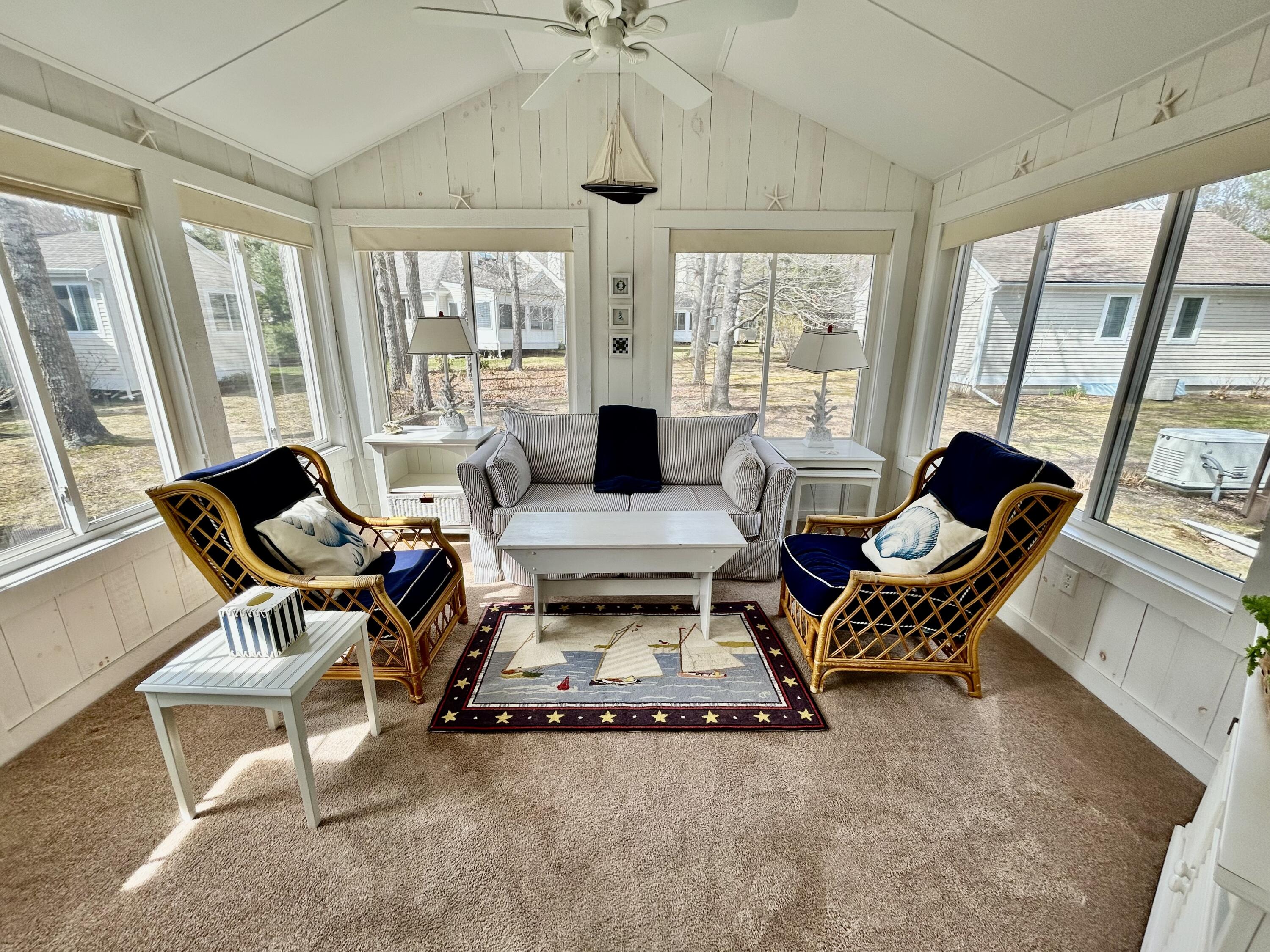 28 Windward Street, Unit 28 Mashpee, MA 02649 - Photo 15 of 37 a living room with furniture large windows and wooden floor