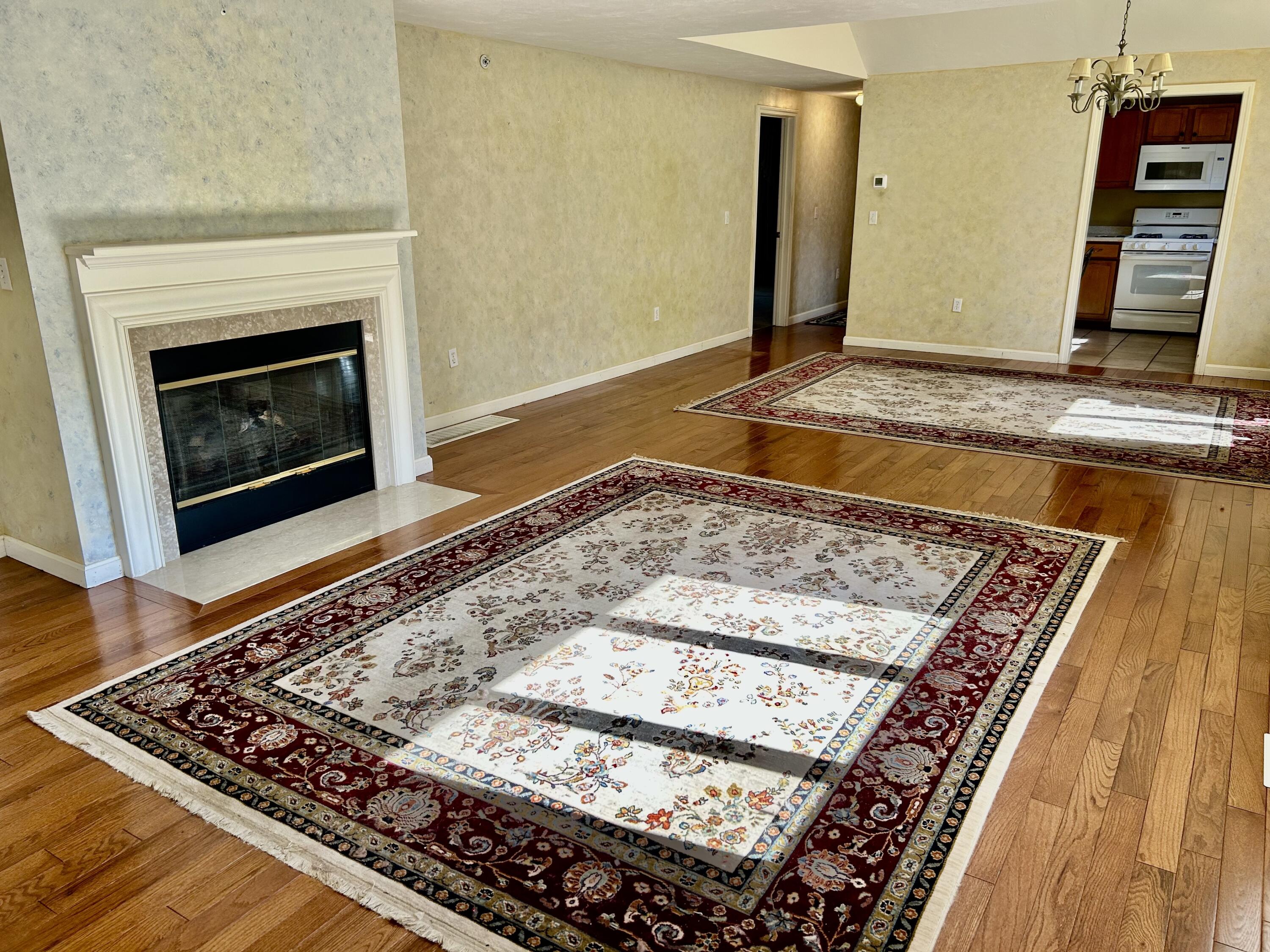 28 Windward Street, Unit 28 Mashpee, MA 02649 - Photo 7 of 37 a view of a fireplace in kitchen