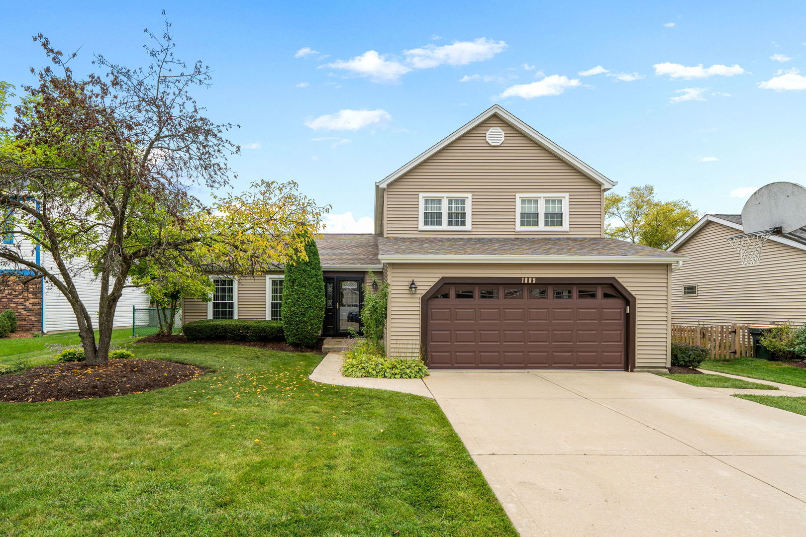 1085 John Drive Hoffman Estates, IL 60169 - Photo 1 of 41 a front view of a house with a yard and garage