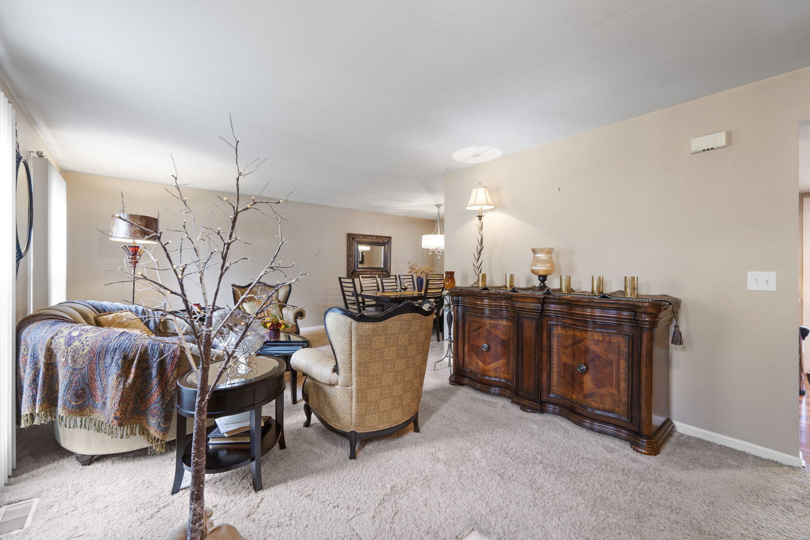 1085 John Drive Hoffman Estates, IL 60169 - Photo 13 of 41 a living room with furniture a flat screen tv and kitchen area
