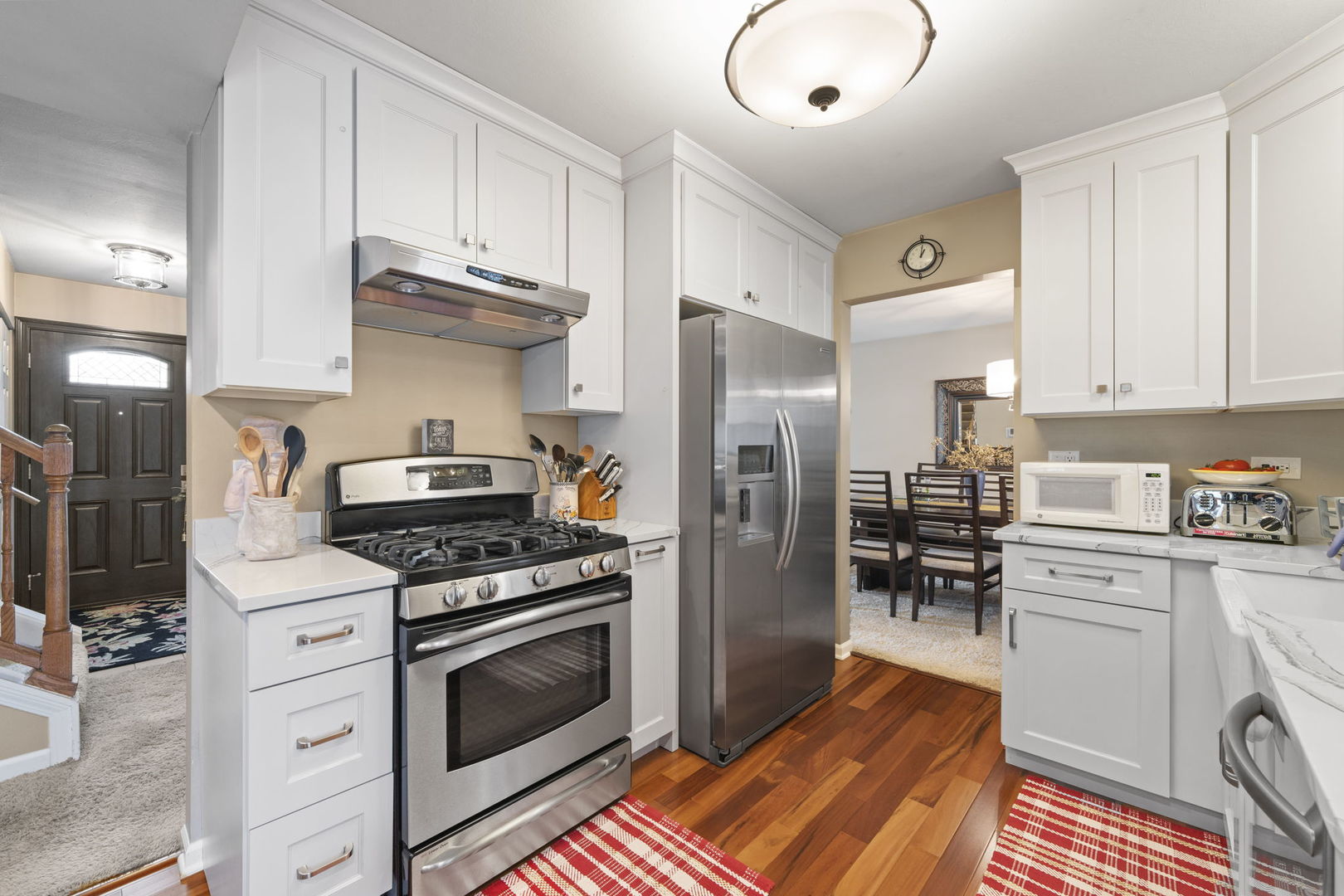 1085 John Drive Hoffman Estates, IL 60169 - Photo 6 of 41 a kitchen with stainless steel appliances a stove a sink and a refrigerator