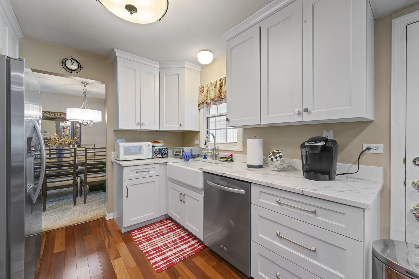 1085 John Drive Hoffman Estates, IL 60169 - Photo 9 of 41 a kitchen with a white cabinets and wooden floor