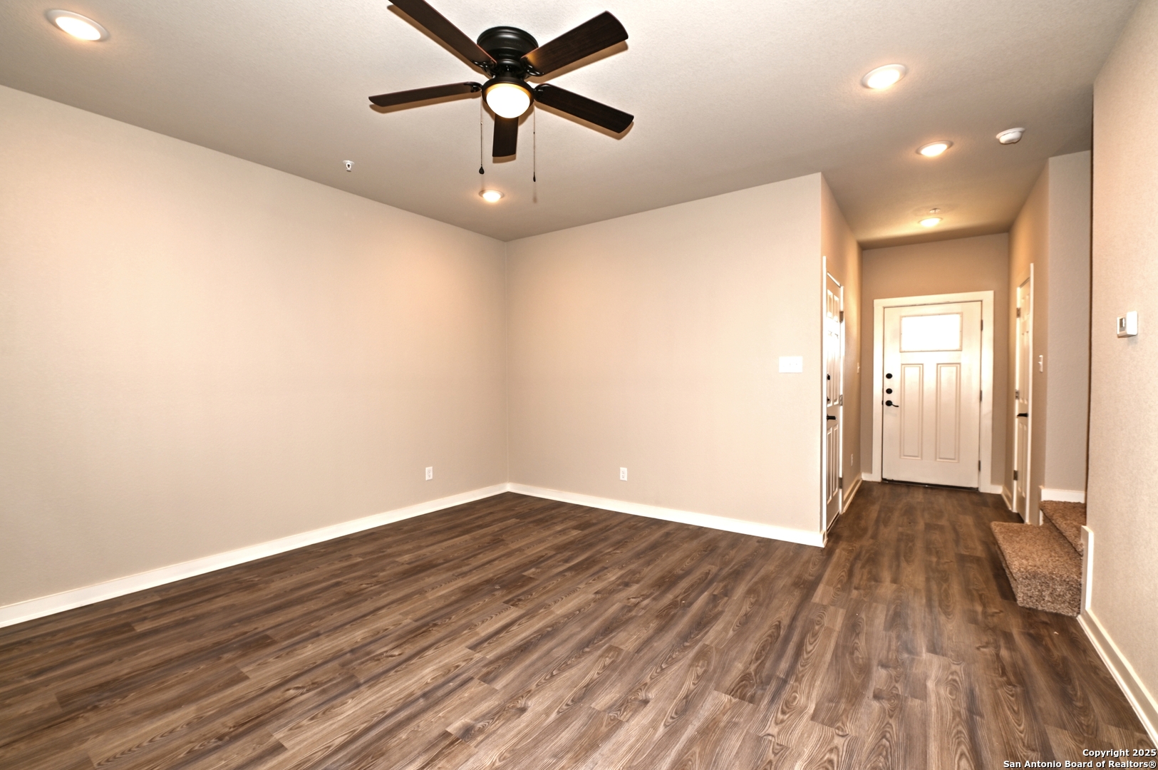 11318 Clearmine, Unit 101 San Antonio, TX 78224 - Photo 12 of 39 an empty room with wooden floor and a ceiling fan