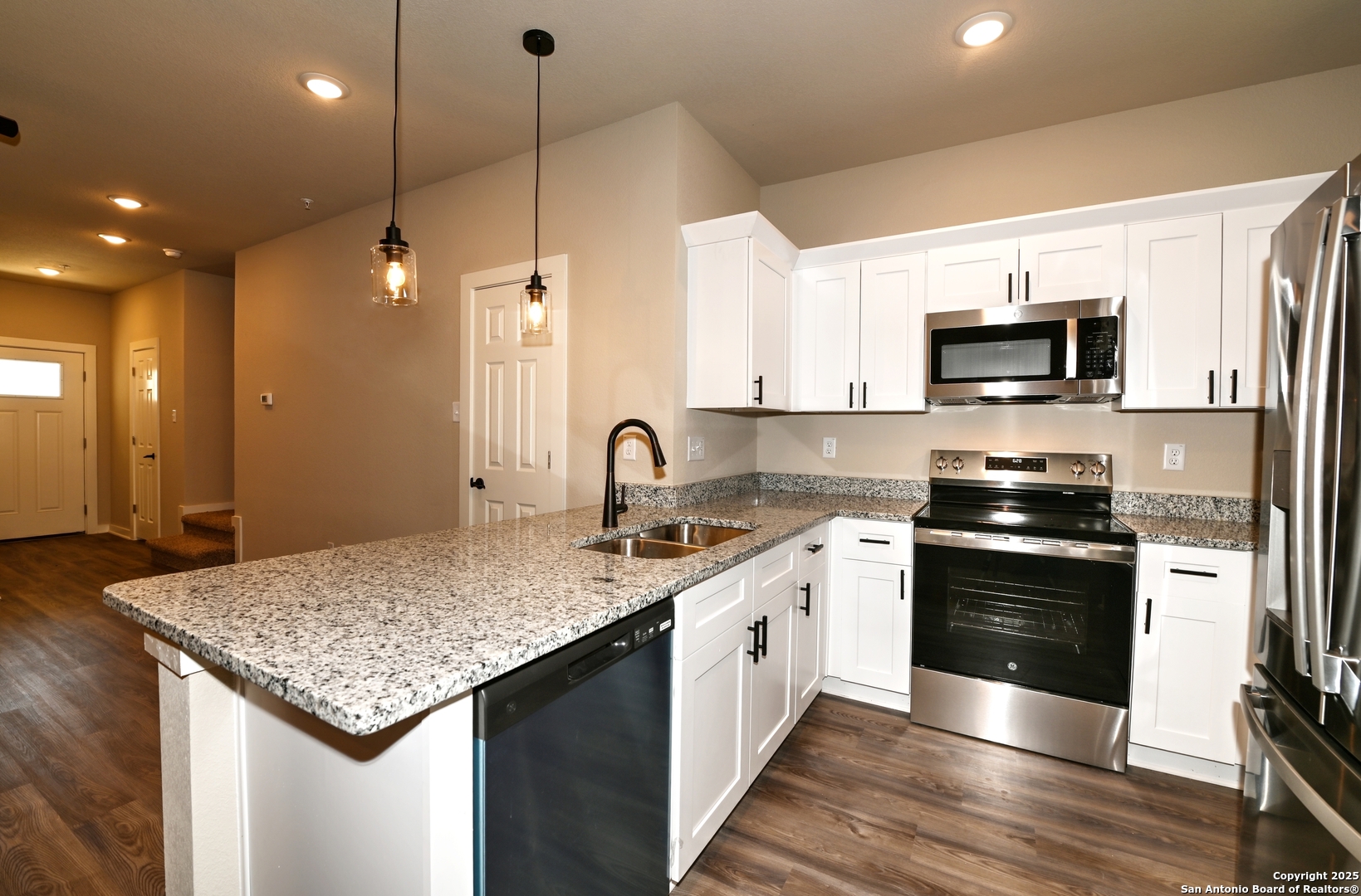 11318 Clearmine, Unit 101 San Antonio, TX 78224 - Photo 16 of 39 a kitchen with a sink stove and microwave