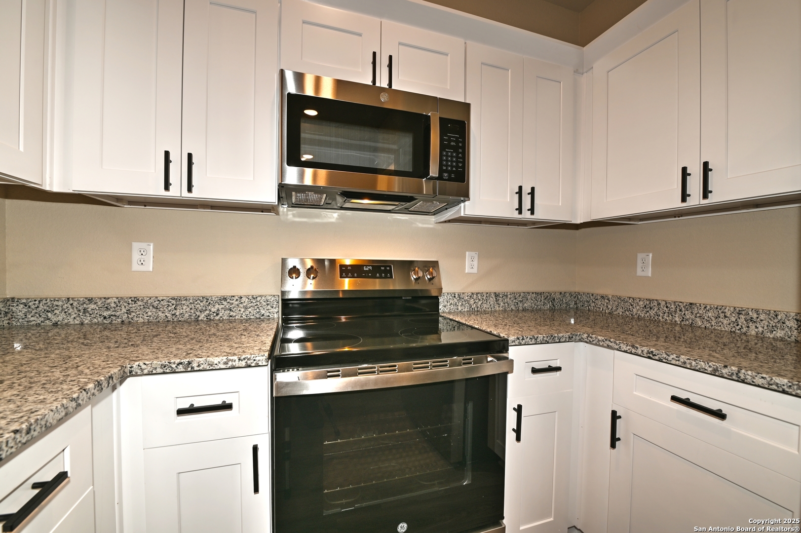 11318 Clearmine, Unit 101 San Antonio, TX 78224 - Photo 17 of 39 a kitchen with a stove and a microwave