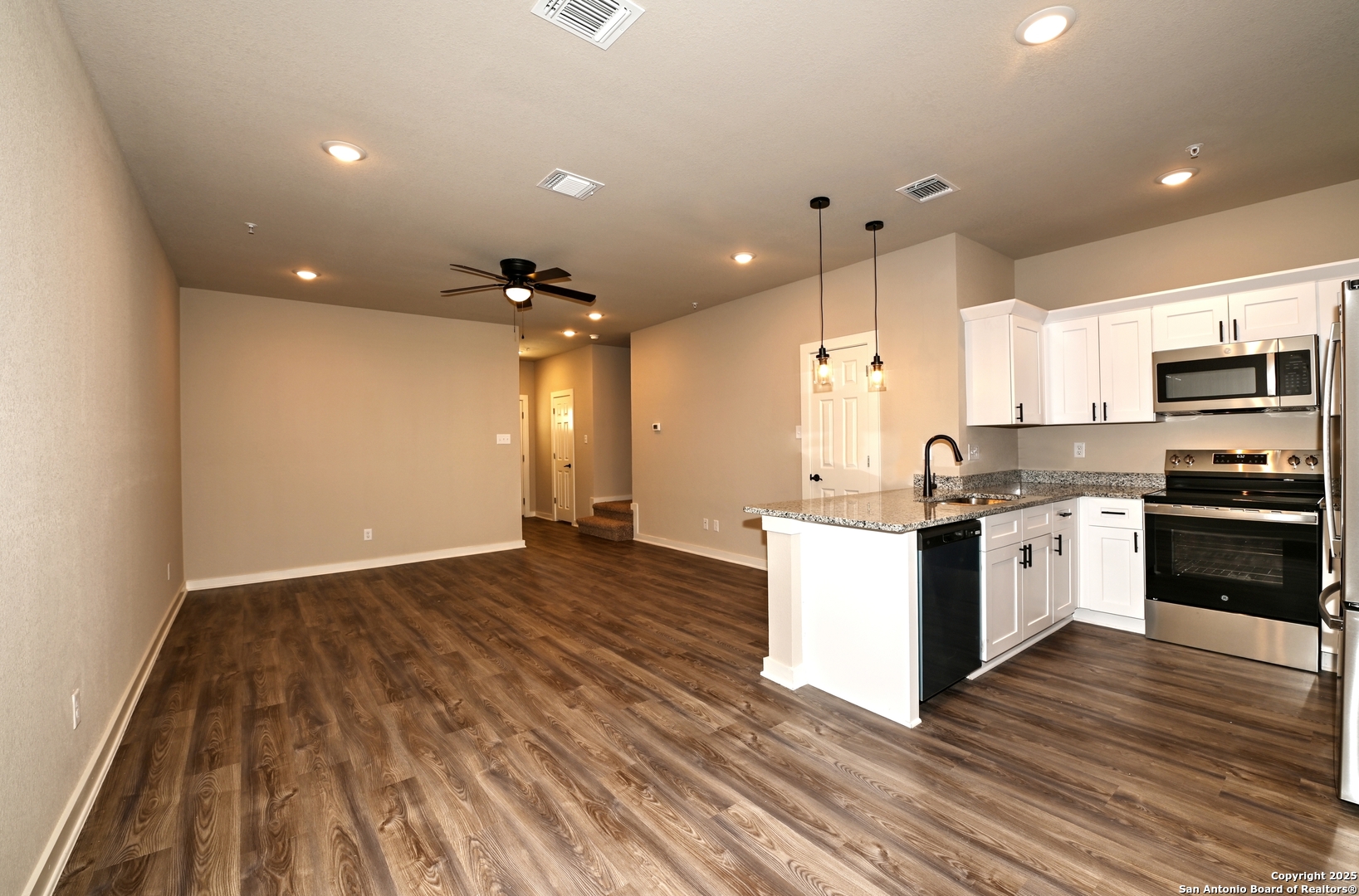 11318 Clearmine, Unit 101 San Antonio, TX 78224 - Photo 20 of 39 a kitchen with a refrigerator and a stove top oven