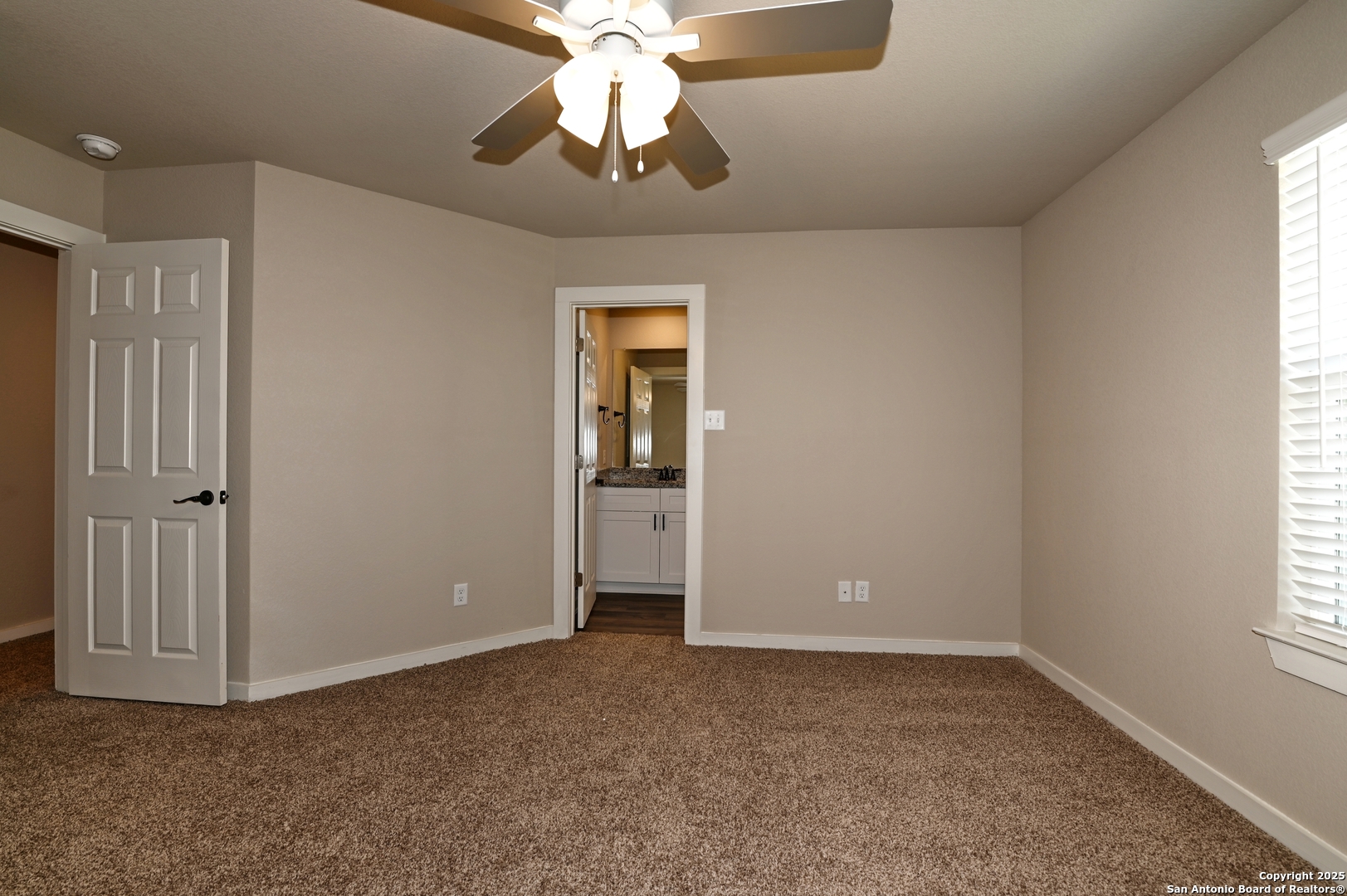 11318 Clearmine, Unit 101 San Antonio, TX 78224 - Photo 28 of 39 an empty room with a chandelier fan and windows