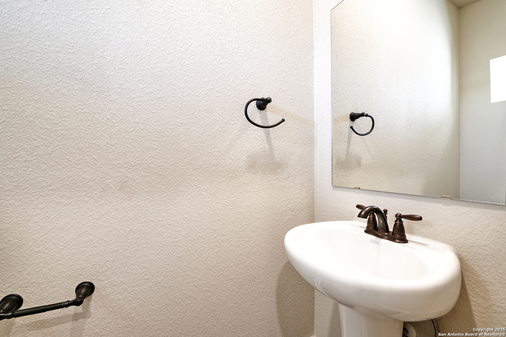 11318 Clearmine, Unit 101 San Antonio, TX 78224 - Photo 5 of 39 a bathroom with a sink and mirror