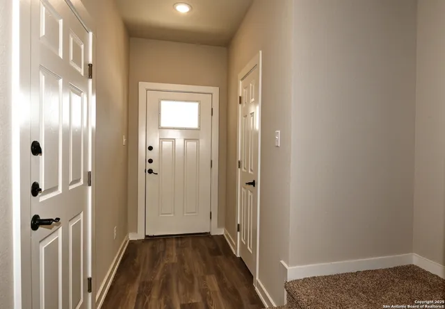 a view of a room with wooden floor