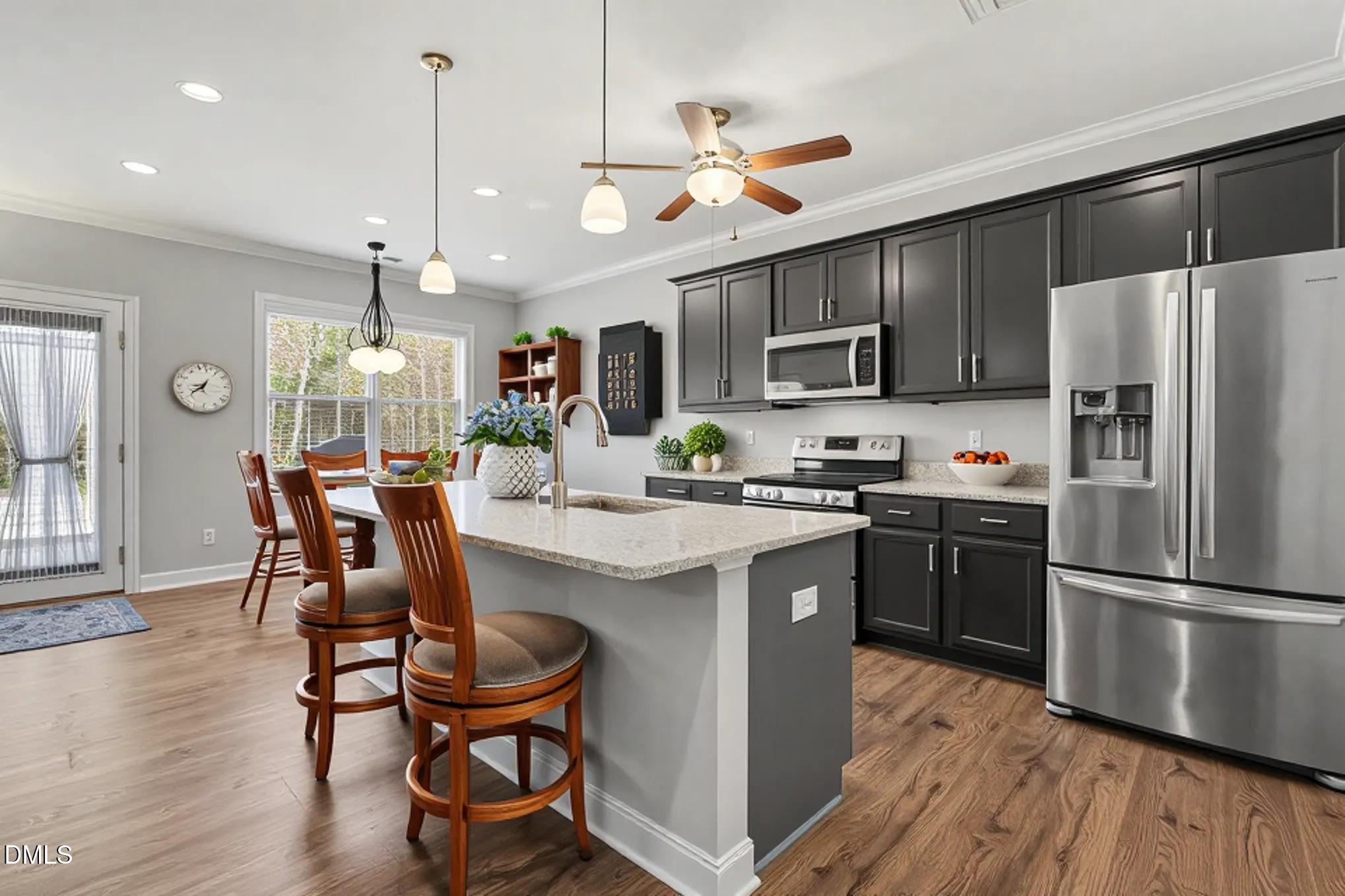 130 Aylebury Ridge Zebulon, NC 27597 - Photo 1 of 41 a kitchen with granite countertop a table chairs microwave and refrigerator