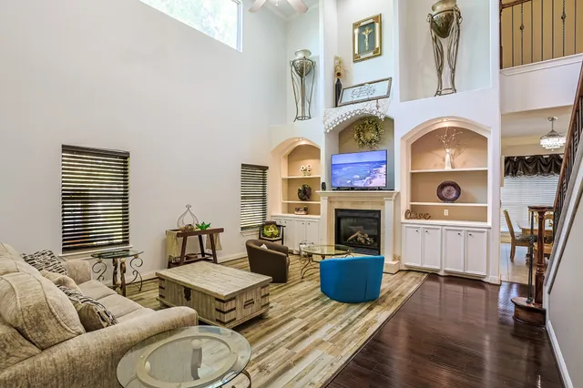 a living room with furniture fireplace and wooden floor