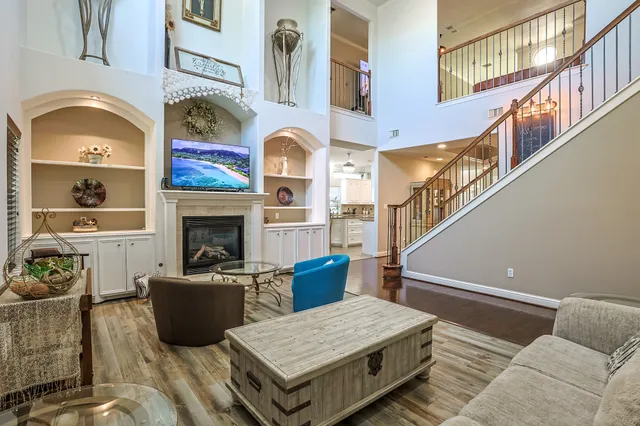 a living room with furniture a fireplace and rug