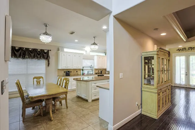 a kitchen with a table chairs and a refrigerator