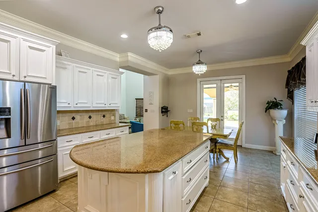 a kitchen with stainless steel appliances granite countertop a sink a stove and refrigerator