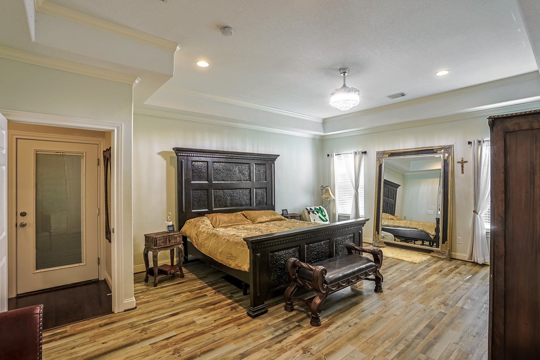 30119 West Geneva Drive Spring, TX 77386 - Photo 24 of 49 Elegant primary suite featuring tray ceilings, recessed lighting, and a private door leading to the backyard patio — a perfect retreat after a long day