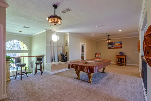 a living room with furniture a chandelier and a large window