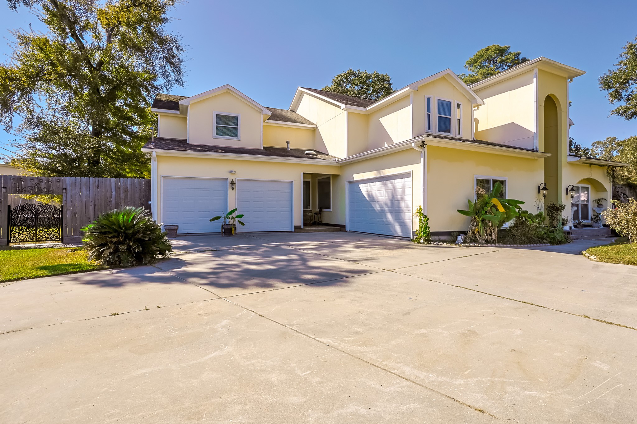 30119 West Geneva Drive Spring, TX 77386 - Photo 3 of 49 Expansive driveway leading to a dual garage and side gate entry — perfect for extra vehicles or weekend projects