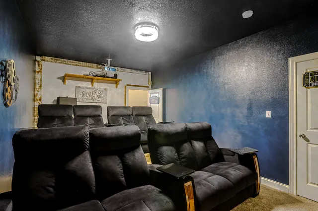 a media room with lots of chairs and a projector screen