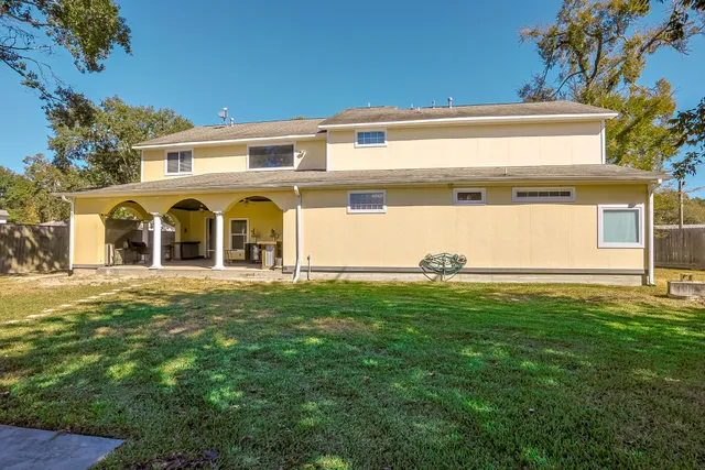a view of a white house with a yard