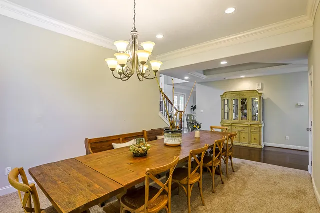 a view of a dining room with furniture and chandelier