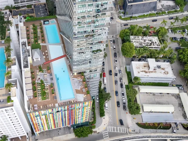 a room with furniture pool table and a flat screen tv