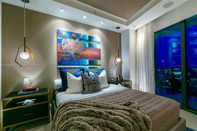 a bedroom with a bed and lamp with the fan