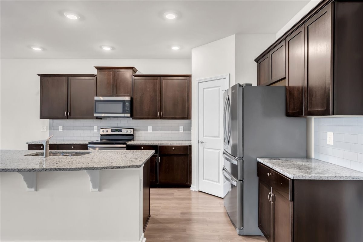 1846 Radnor Road Lebanon, TN 37087 - Photo 12 of 59 a kitchen with kitchen island granite countertop stainless steel appliances and refrigerator
