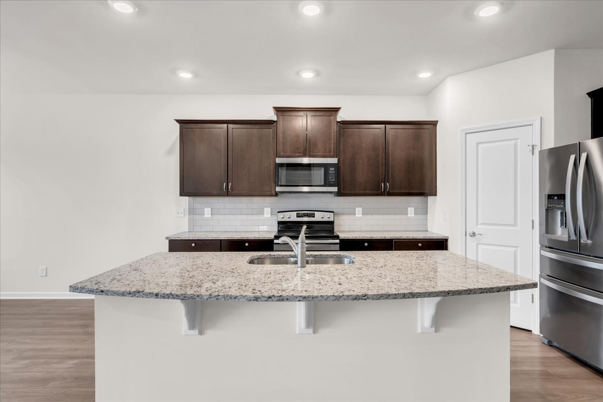 1846 Radnor Road Lebanon, TN 37087 - Photo 13 of 59 a kitchen with stainless steel appliances granite countertop a sink refrigerator and microwave
