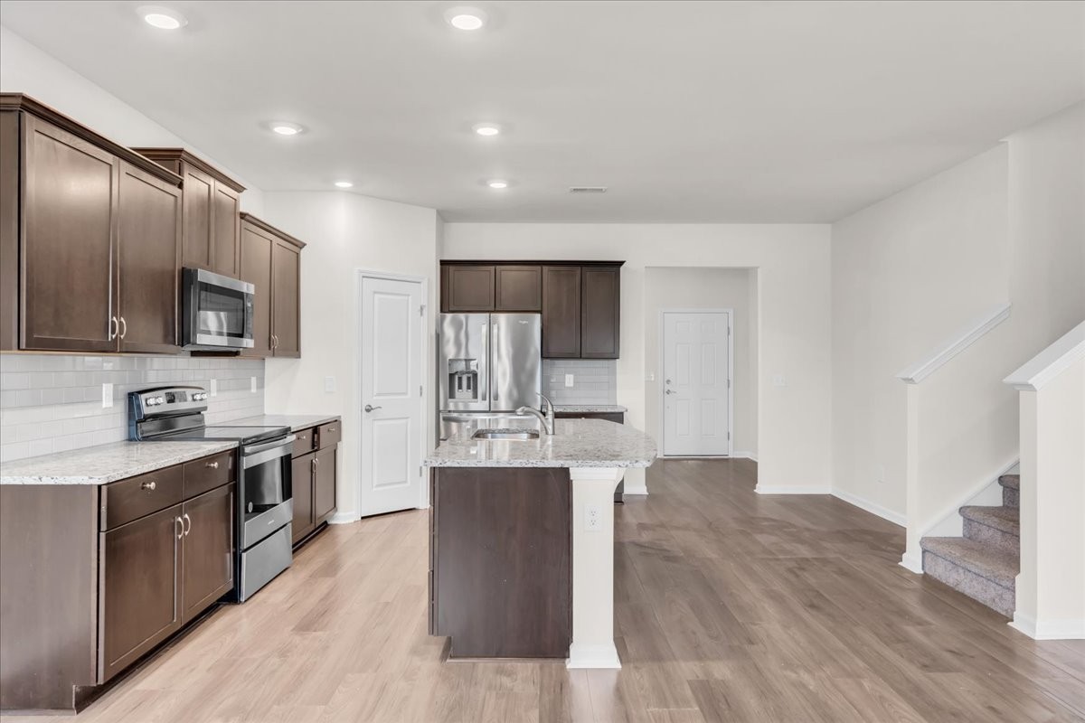 1846 Radnor Road Lebanon, TN 37087 - Photo 16 of 59 a large kitchen with cabinets wooden floor and stainless steel appliances