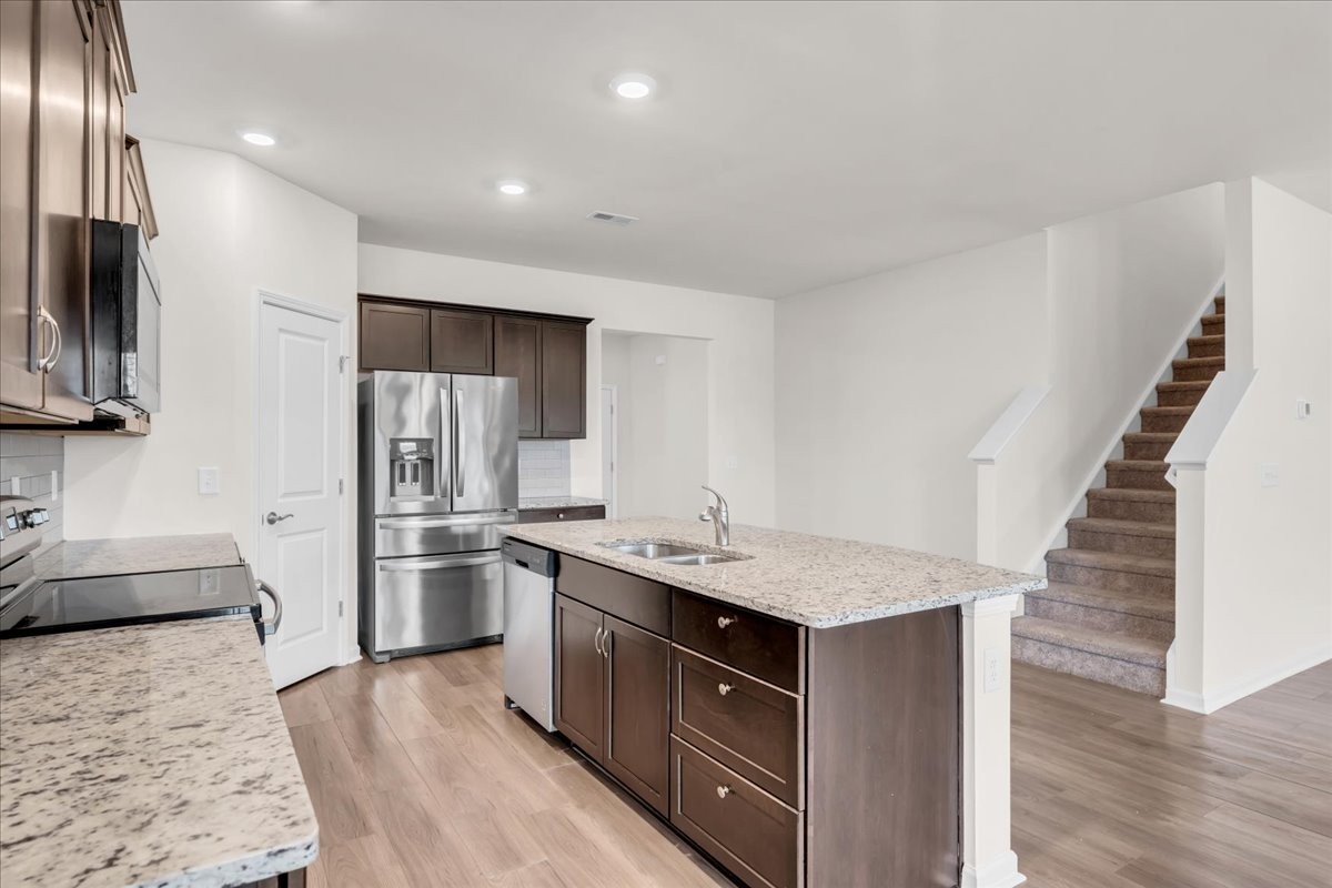 1846 Radnor Road Lebanon, TN 37087 - Photo 19 of 59 a kitchen with stainless steel appliances granite countertop a sink stove and refrigerator
