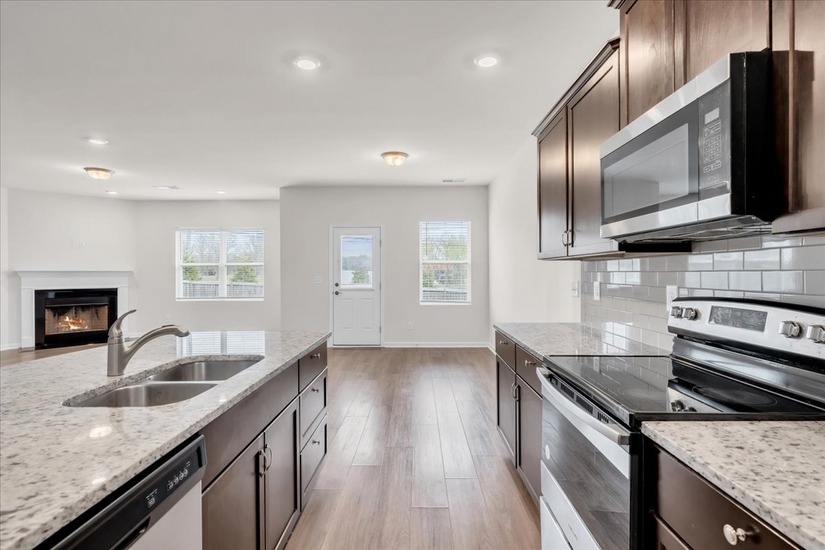 1846 Radnor Road Lebanon, TN 37087 - Photo 20 of 59 a kitchen with stainless steel appliances granite countertop a sink a stove and a wooden floors