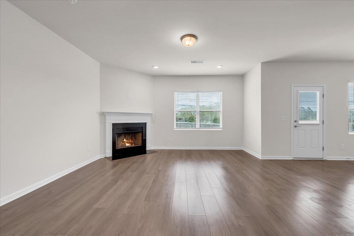 1846 Radnor Road Lebanon, TN 37087 - Photo 28 of 59 an empty room with wooden floor fireplace and windows