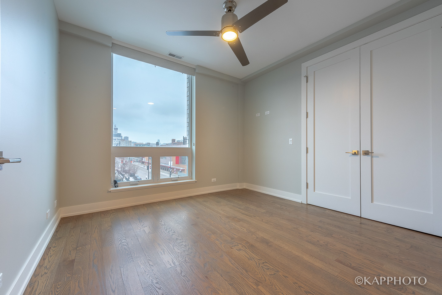 236 South Racine Avenue, Unit 401 Chicago, IL 60607 - Photo 21 of 24 wooden floor in an empty room with a window